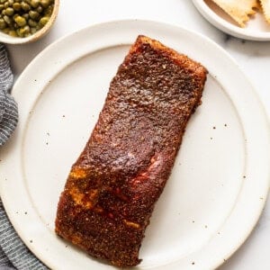 Smoked salmon resting on a plate.