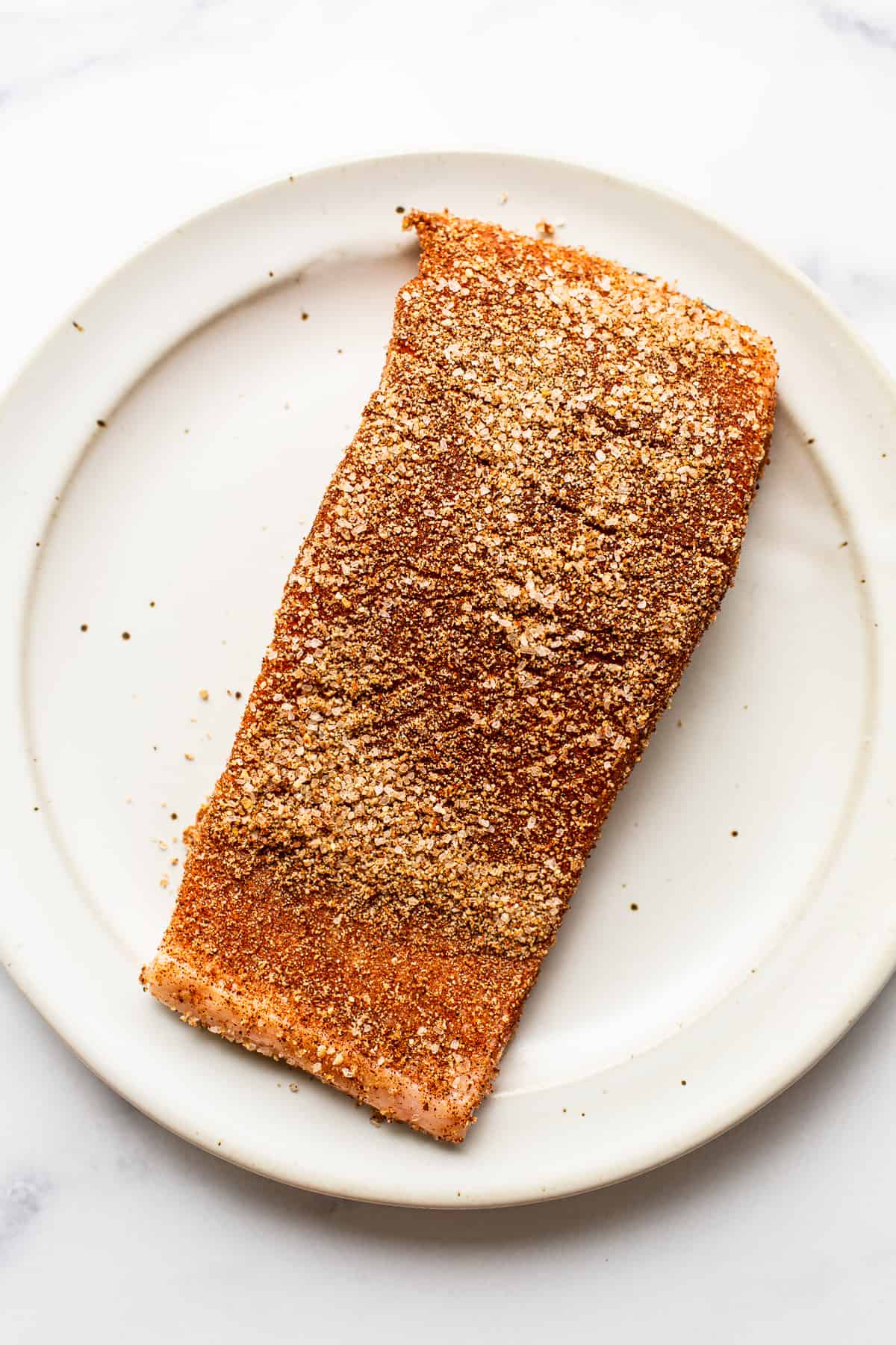 seasoned salmon on plate.