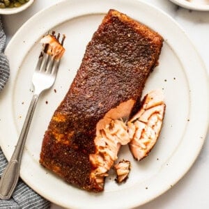 smoked salmon with fork on plate.