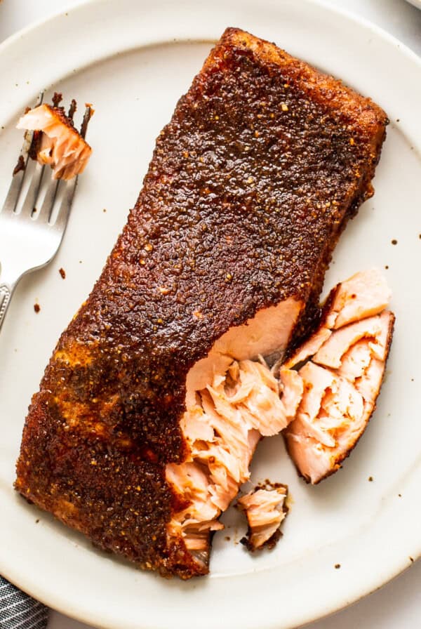 smoked salmon with fork on plate.