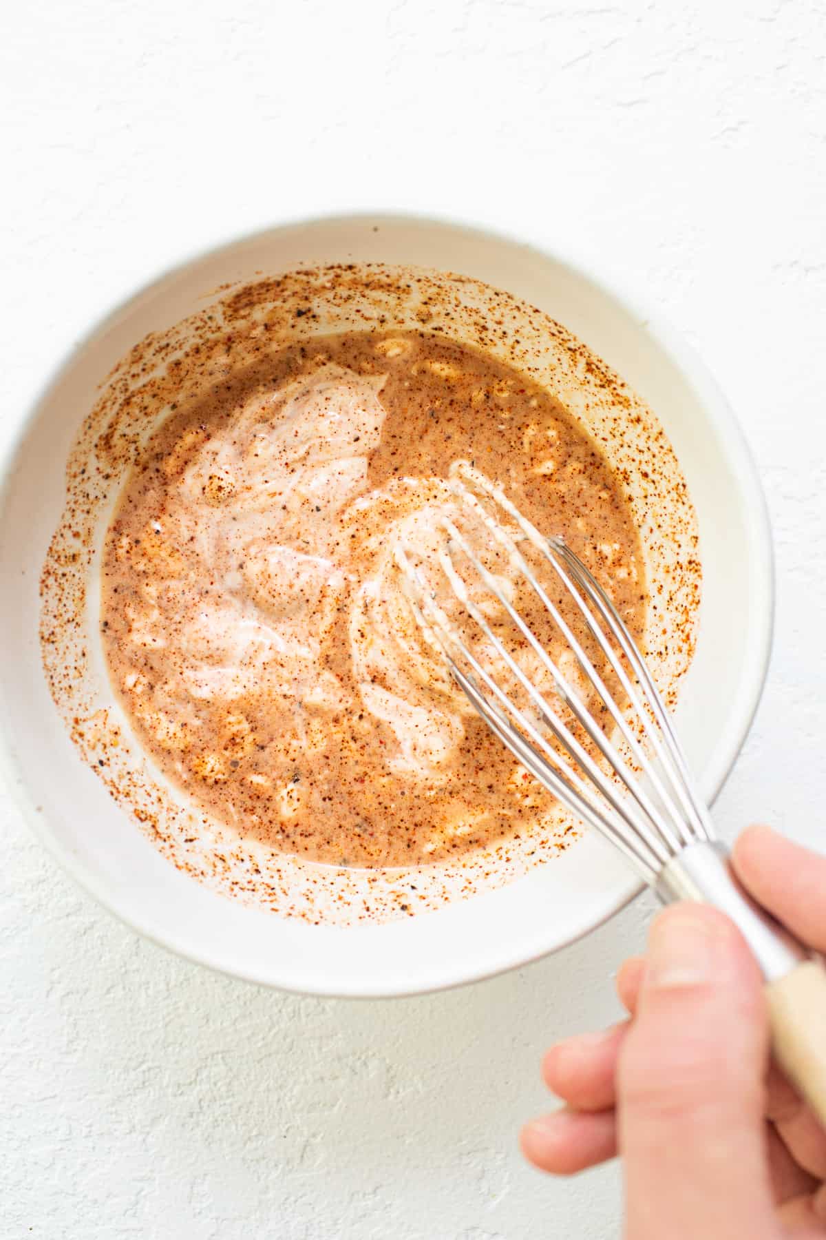 Burger sauce ingredients being whisked together in a bowl.