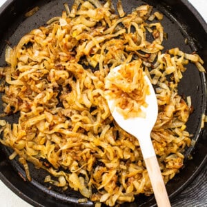 Browned caramelized onions in a skillet.