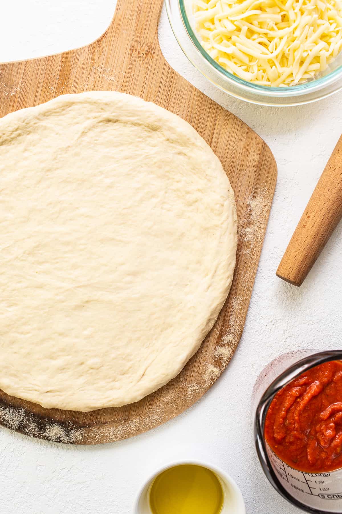 pizza crust on cutting board.