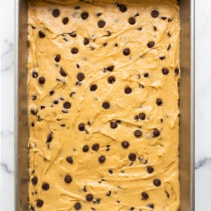 Chocolate chip cookie bars in a baking pan.