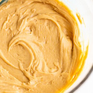 A bowl of peanut butter batter in a glass bowl.