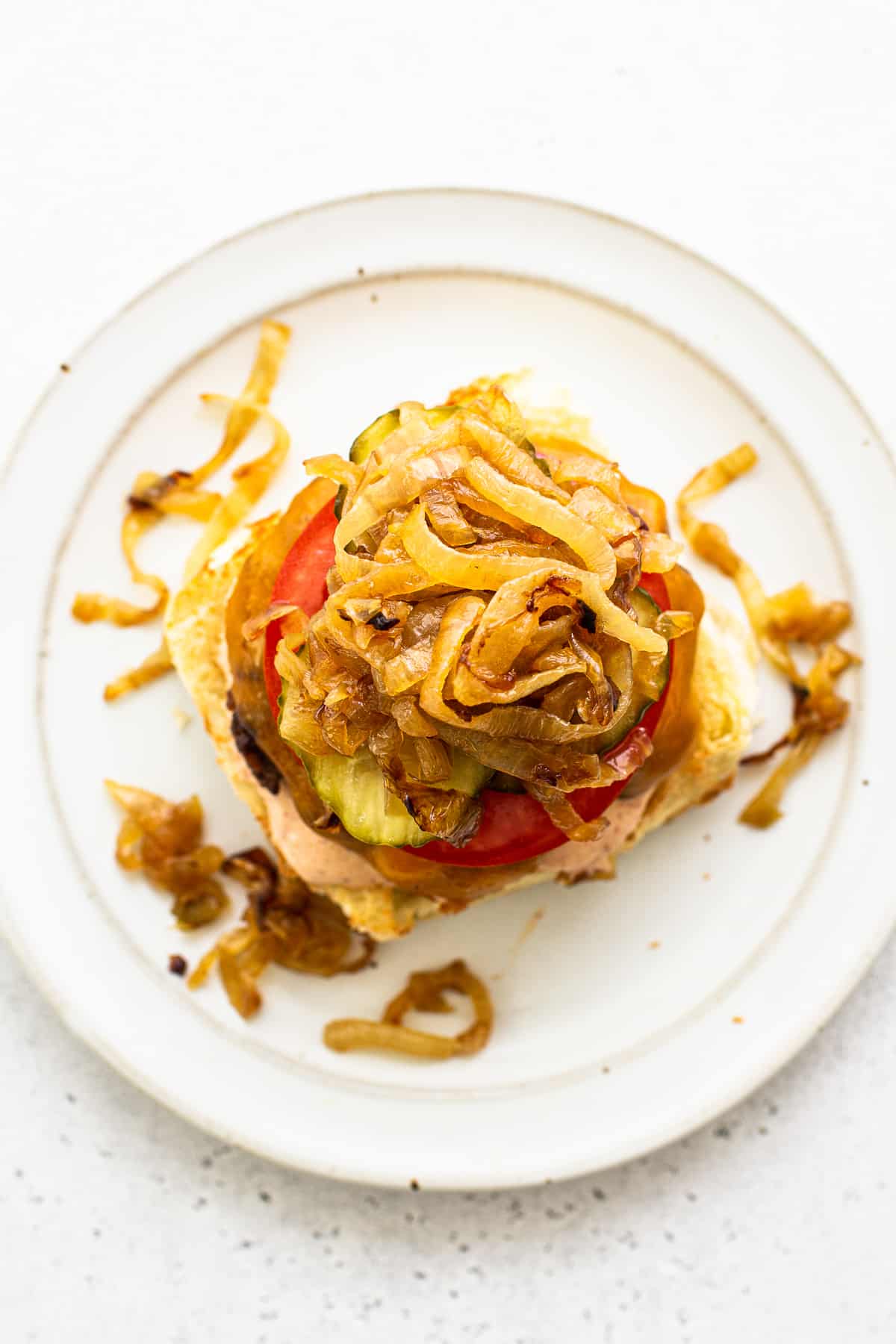 Homemade burgers topped with caramelized onions.