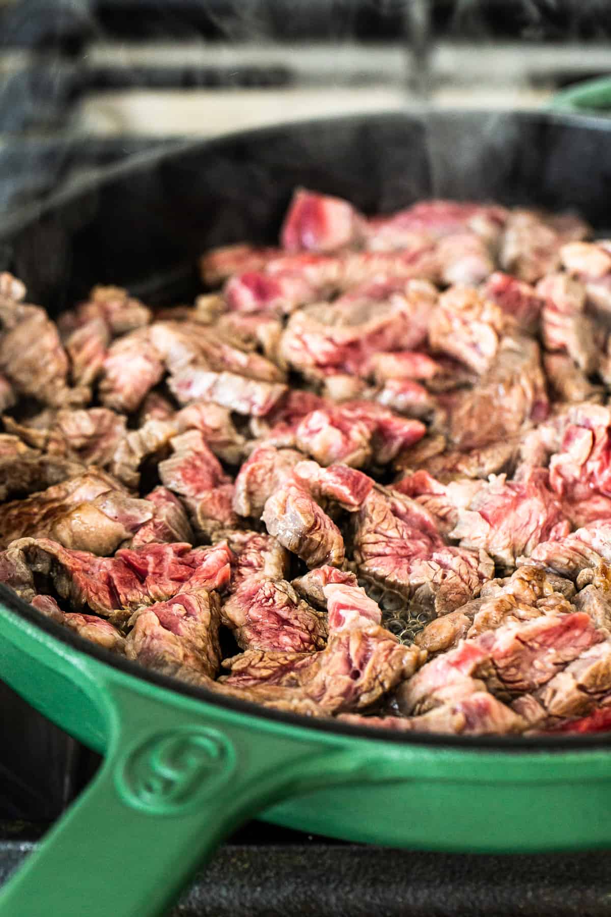 Flank steak in a cast iron skillet.