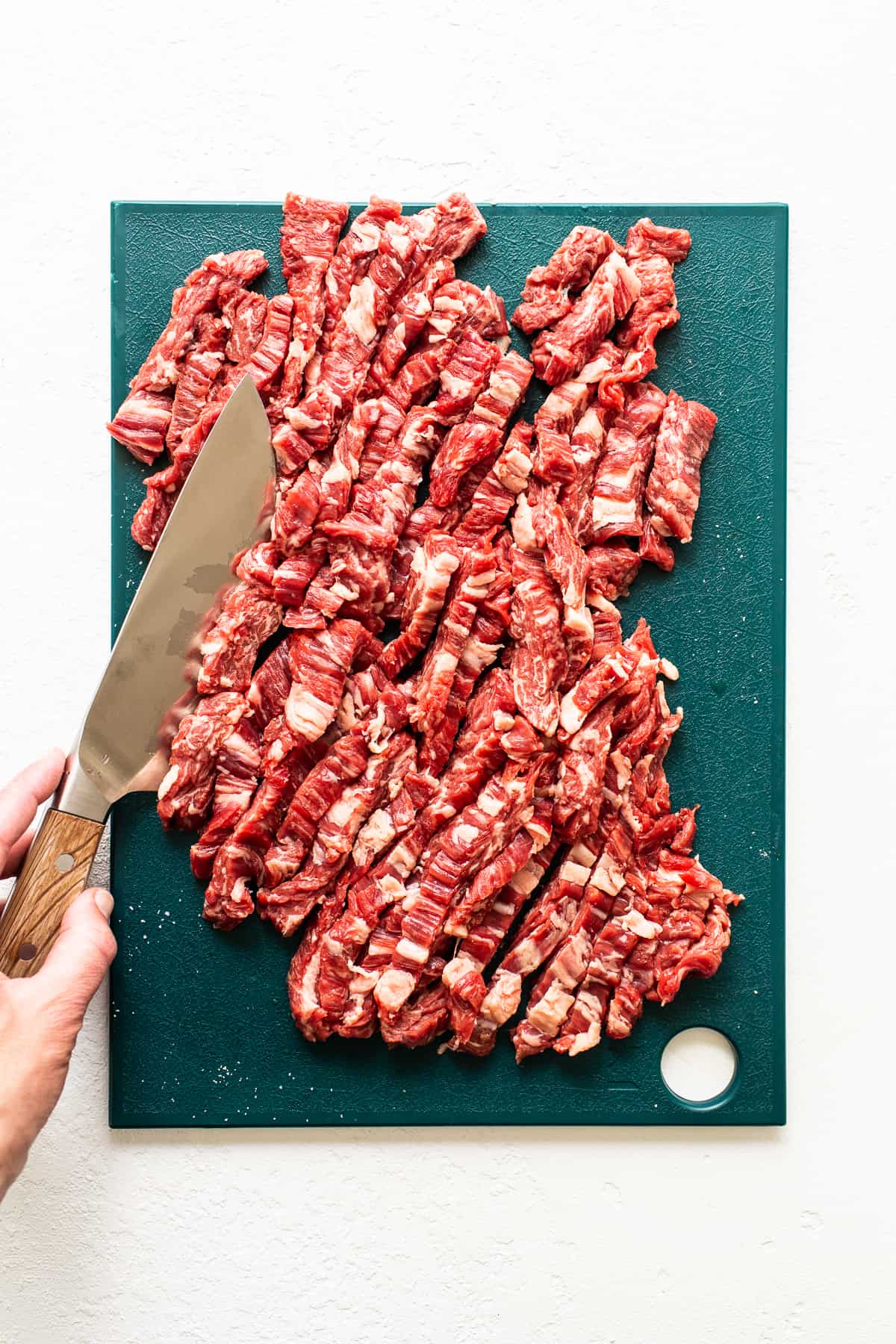 Sliced flank steak on a cutting board.