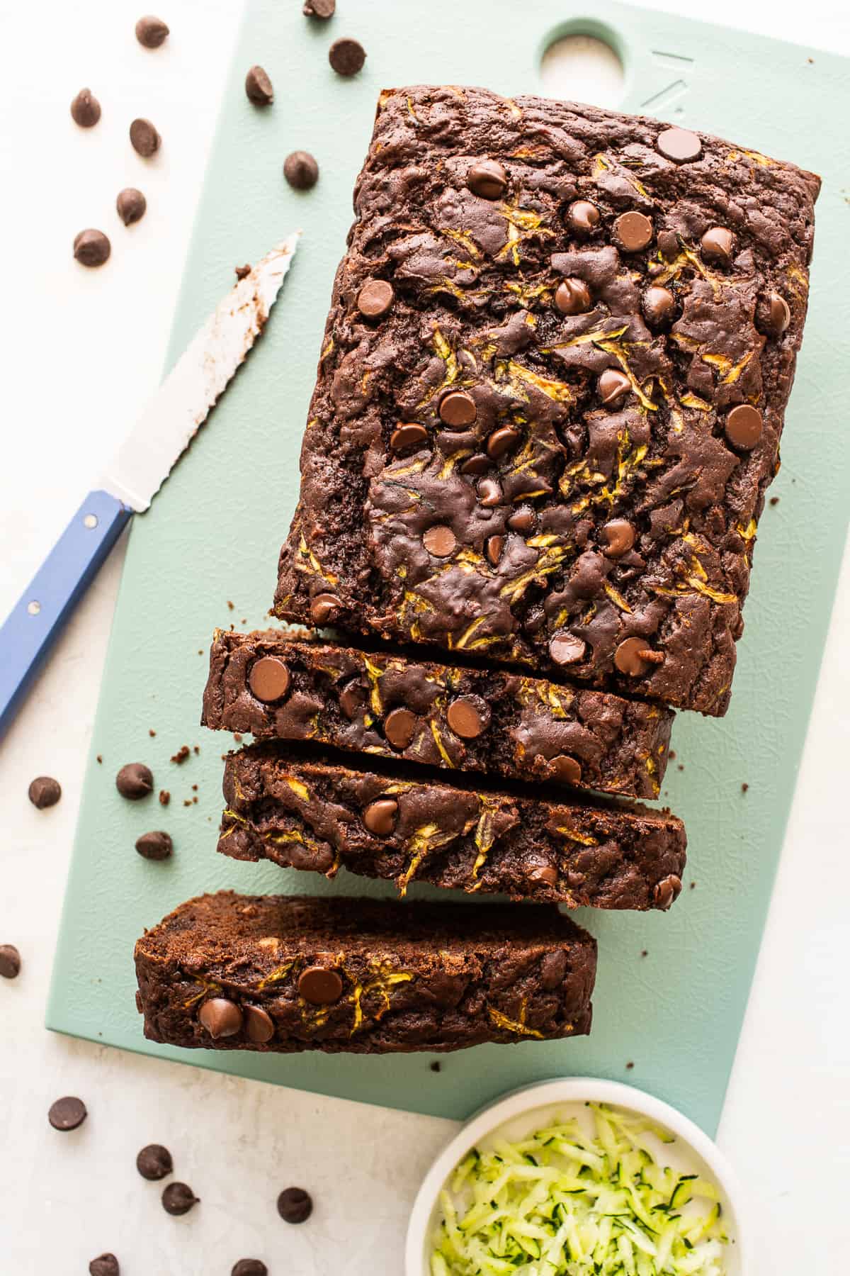 Loaf of chocolate zucchini bread cut into slices.