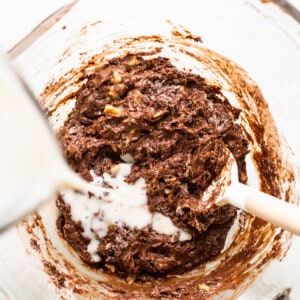 Chocolate cookie batter being mixed in a bowl.