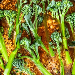 A pan with broccoli in it cooking on the stove.