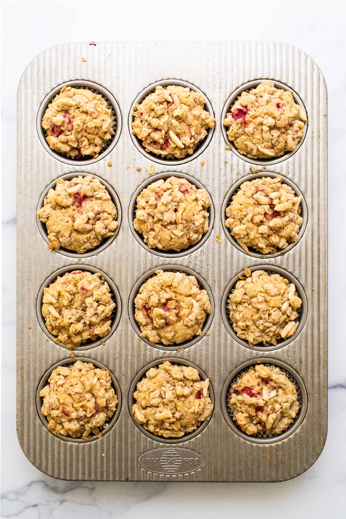 raspberry muffins in muffin tin.