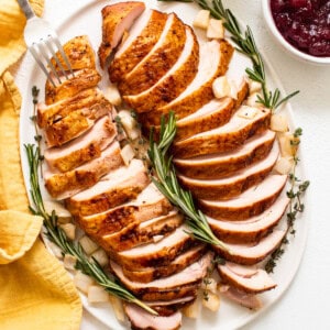 Smoked turkey breast sliced on a plate.