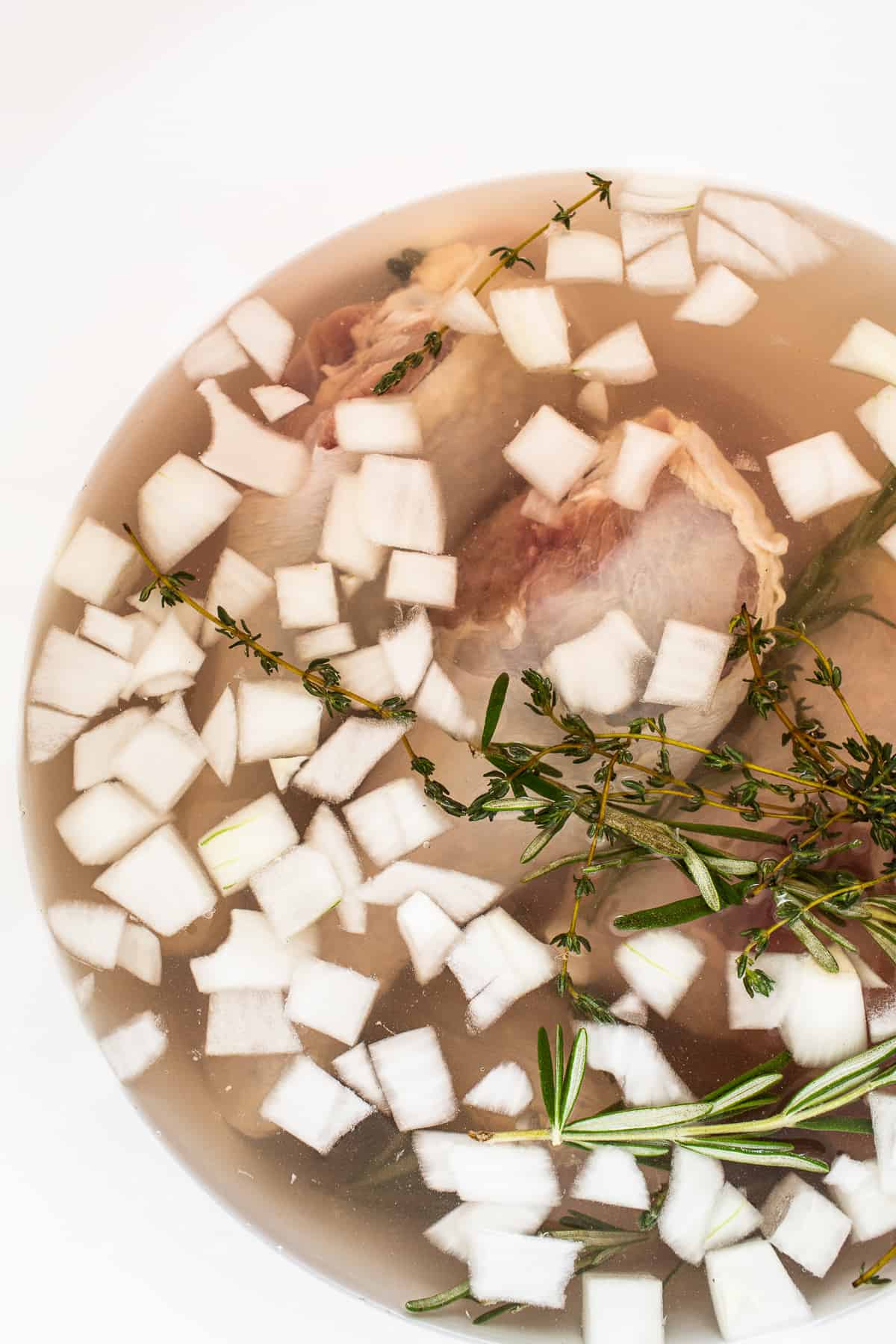 Turkey brine in a bucket with turkey legs.