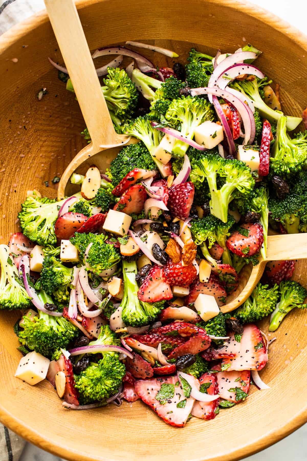 Strawberry broccoli salad in a wooden bowl.