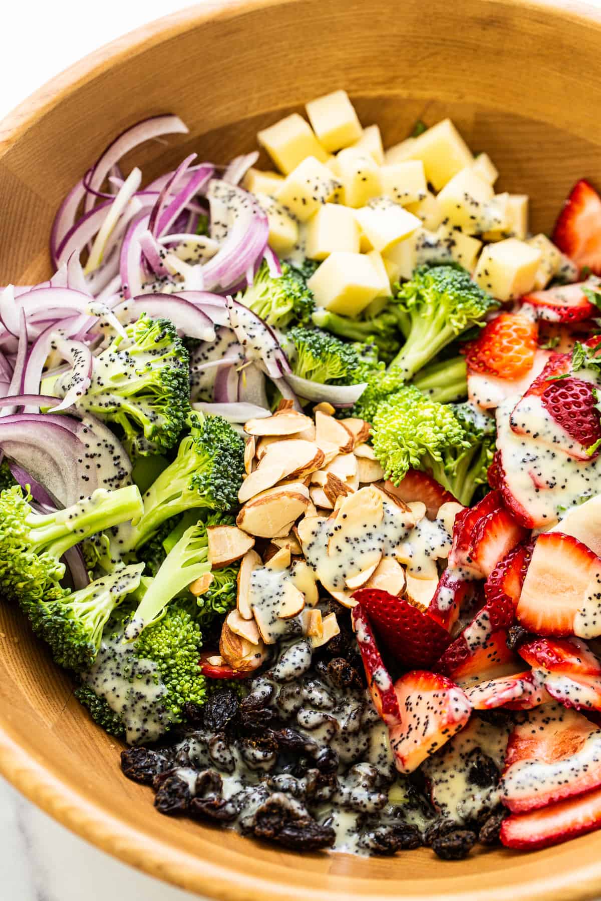 Strawberry broccoli salad topped with poppy seed dressing.