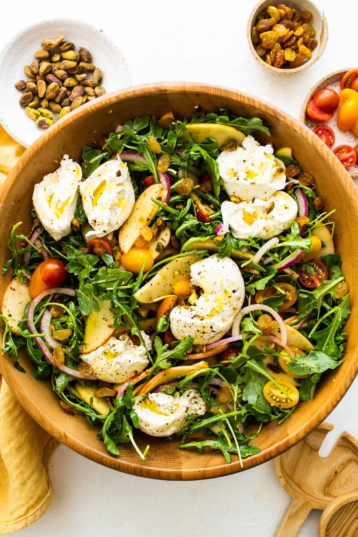 Apple burrata salad with ripped burrata on top of the salad.