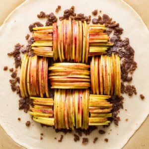 A pie with apples on top of a sheet of paper.