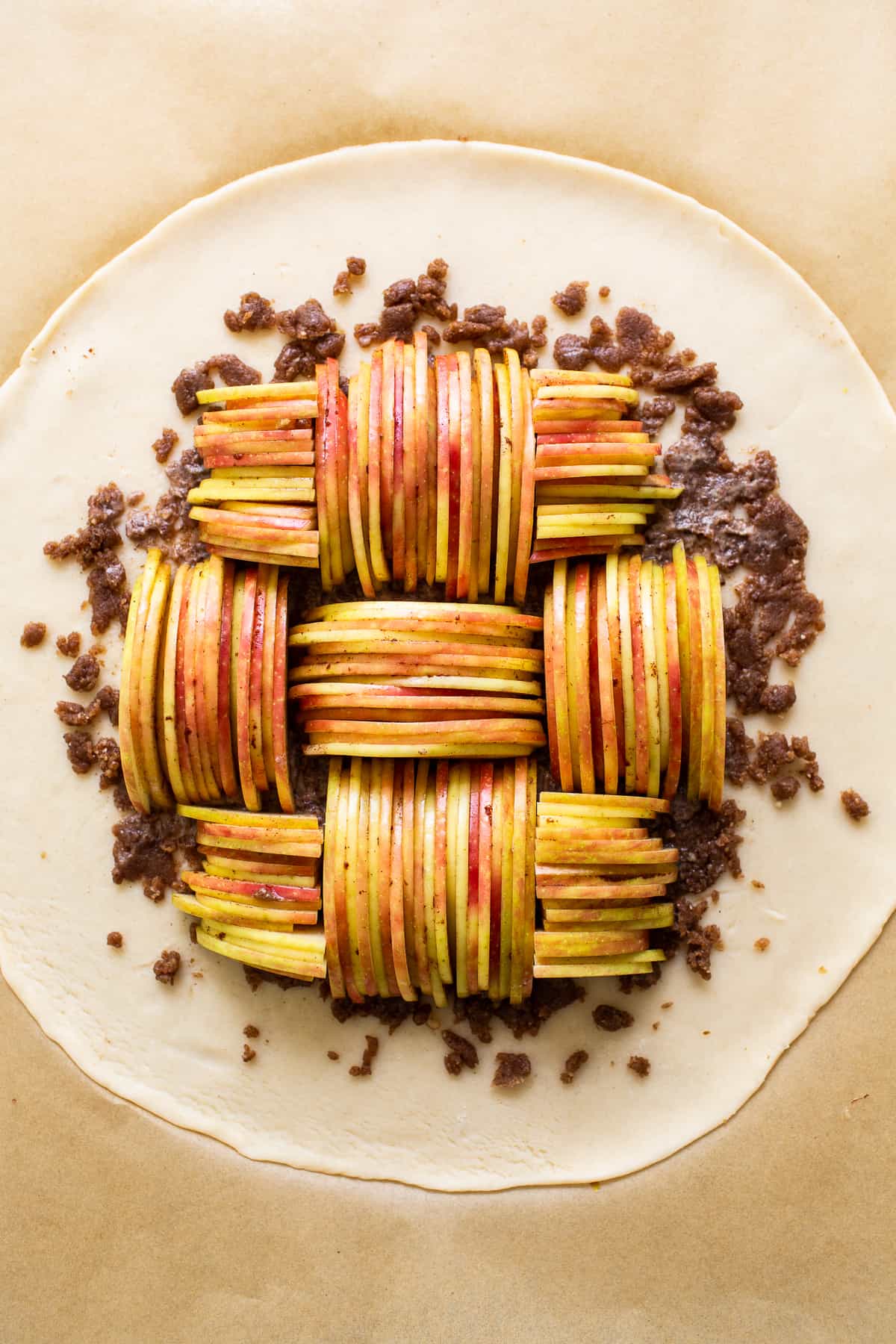 Uncooked apple galette on pie crust.