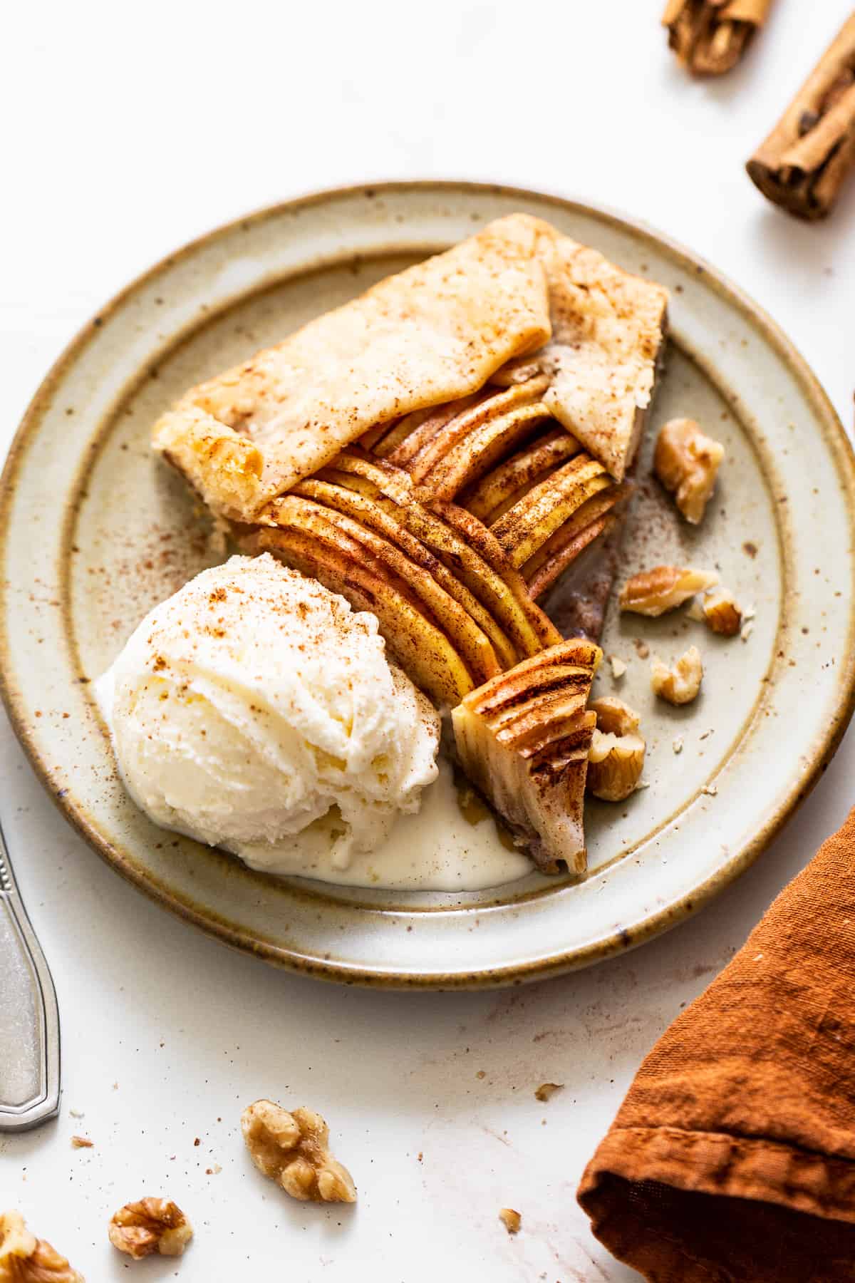 A slice of apple galette with ice cream.