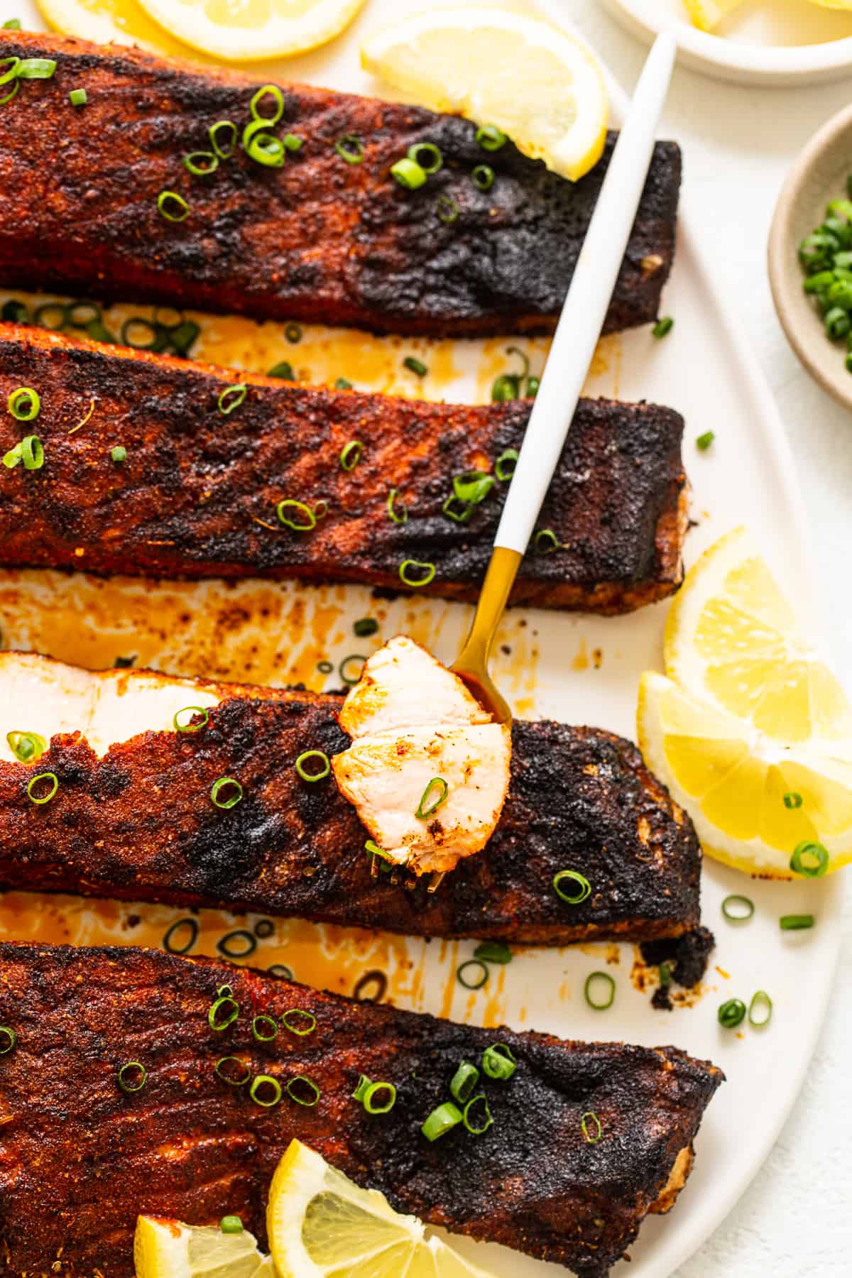 Blacked salmon served with green onion and fresh lemon. 