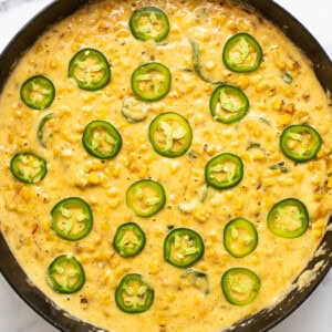 A skillet filled with corn and jalapenos.