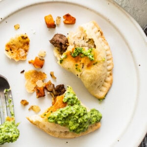 Sweet Potato Ground Beef Emanadas on a plate with topping.