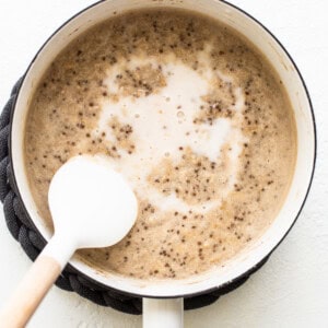 A pot of coffee with a spoon in it.