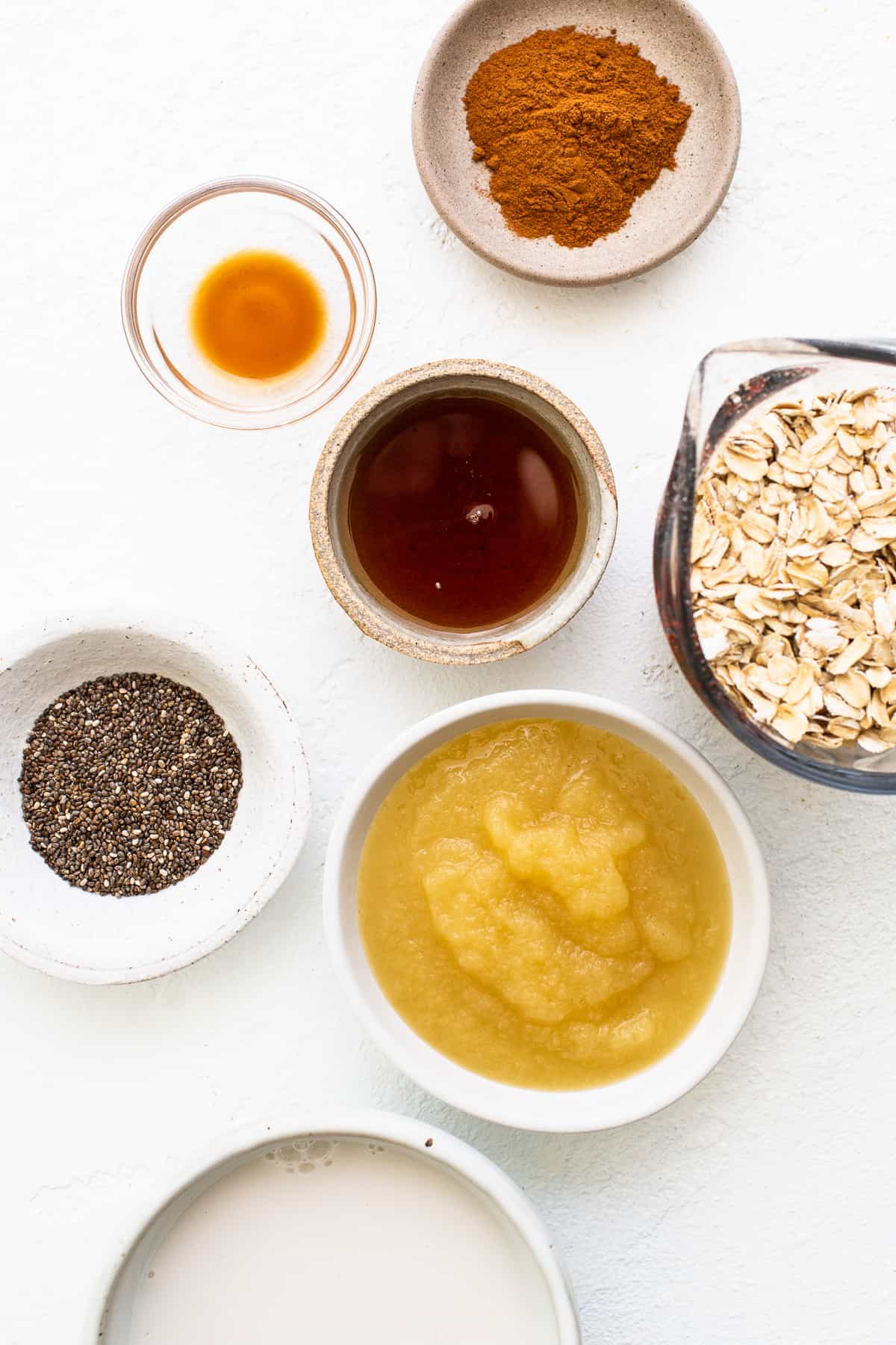 Ingredients for apple cinnamon oatmeal in bowls.