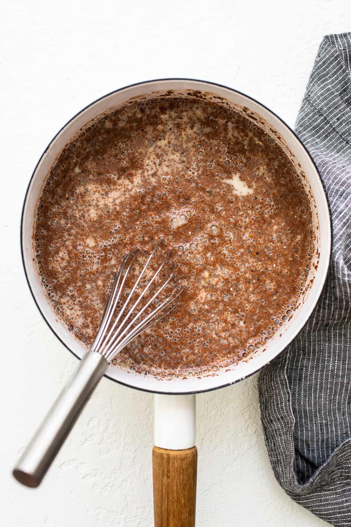 Apple cinnamon oatmeal boiling in a pot.