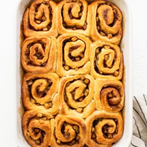 Cinnamon rolls in a white baking dish.