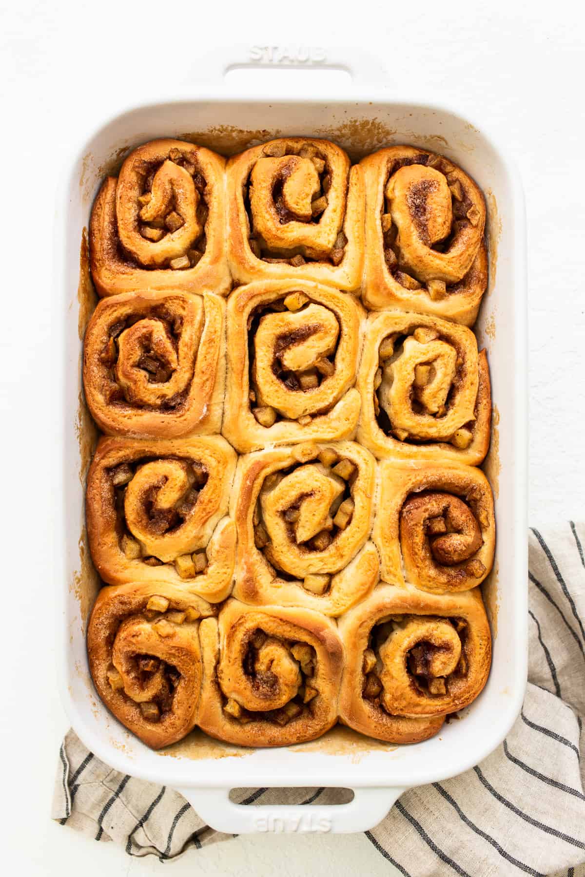 Apple cinnamon rolls in a casserole dish.