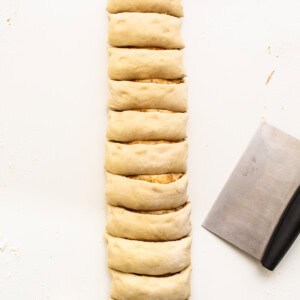 A slice of bread with a knife next to it.