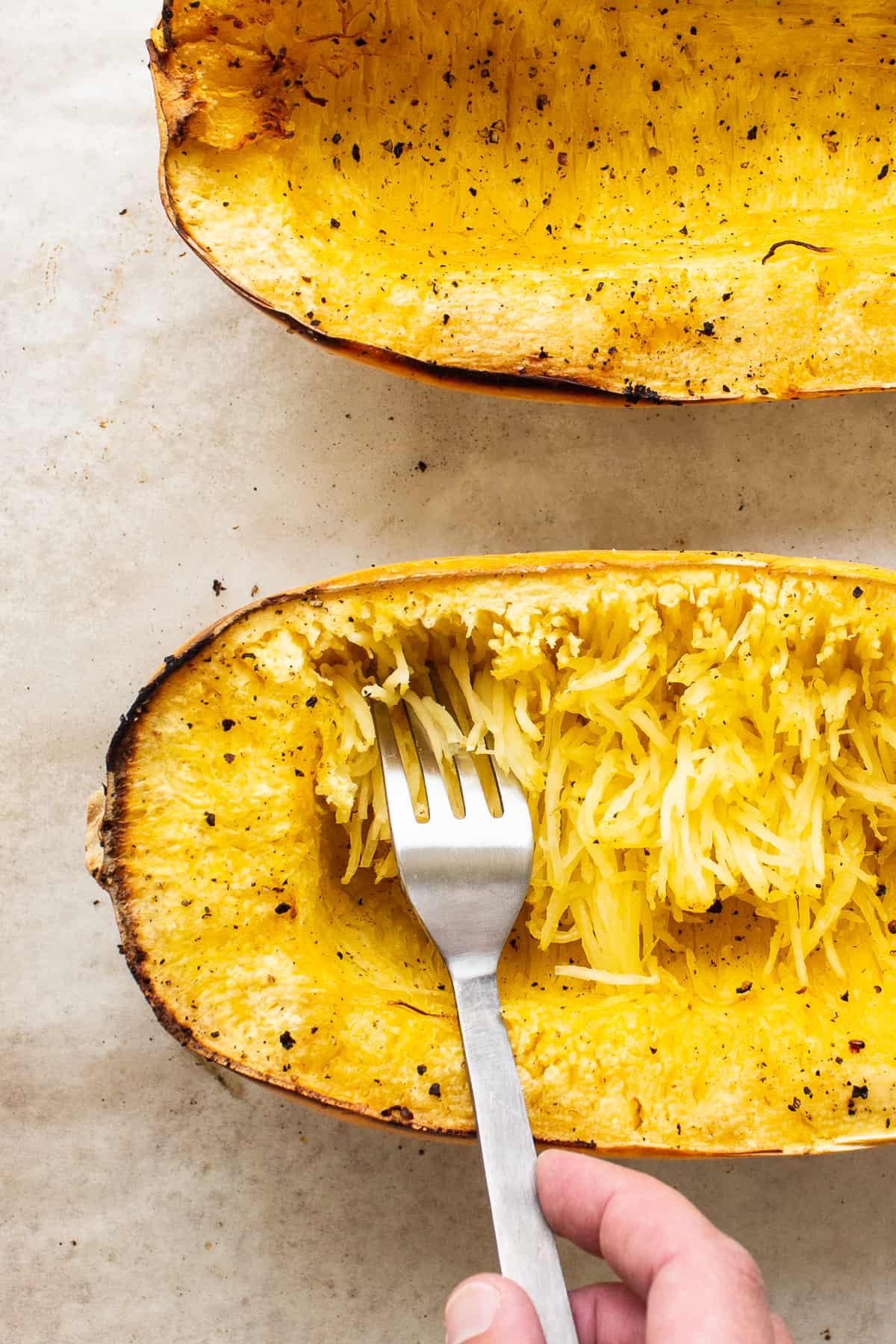 forking spaghetti squash on plate.