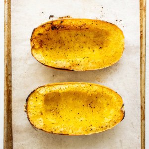 sliced spaghetti squash on baking sheet.