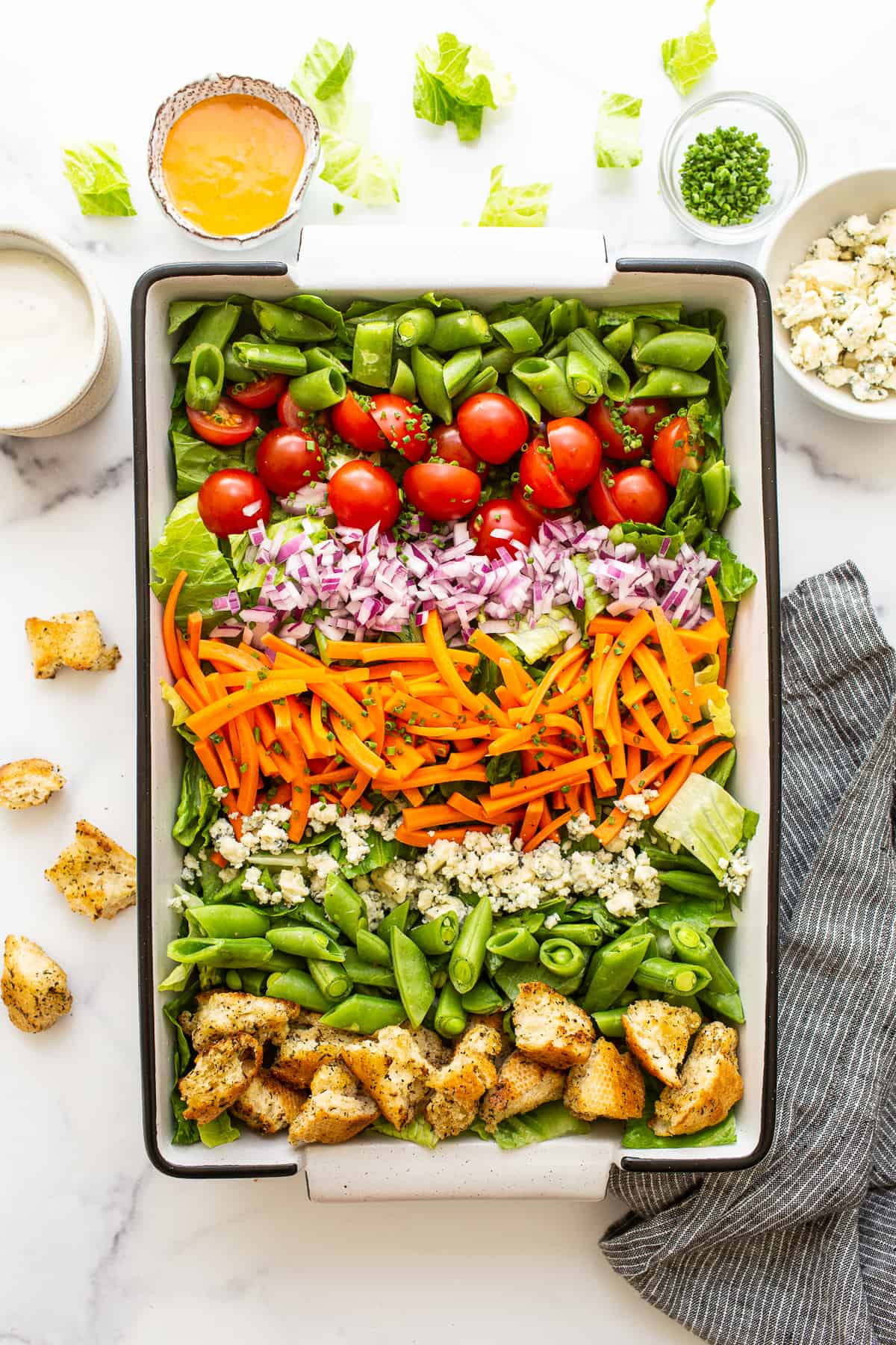 Garden salad in a serving dish topped with homemade croutons.