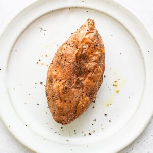 A cooked sweet potato on a plate.