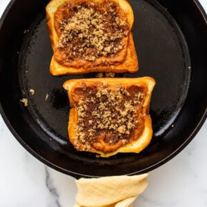 Two slices of french toast in a skillet.