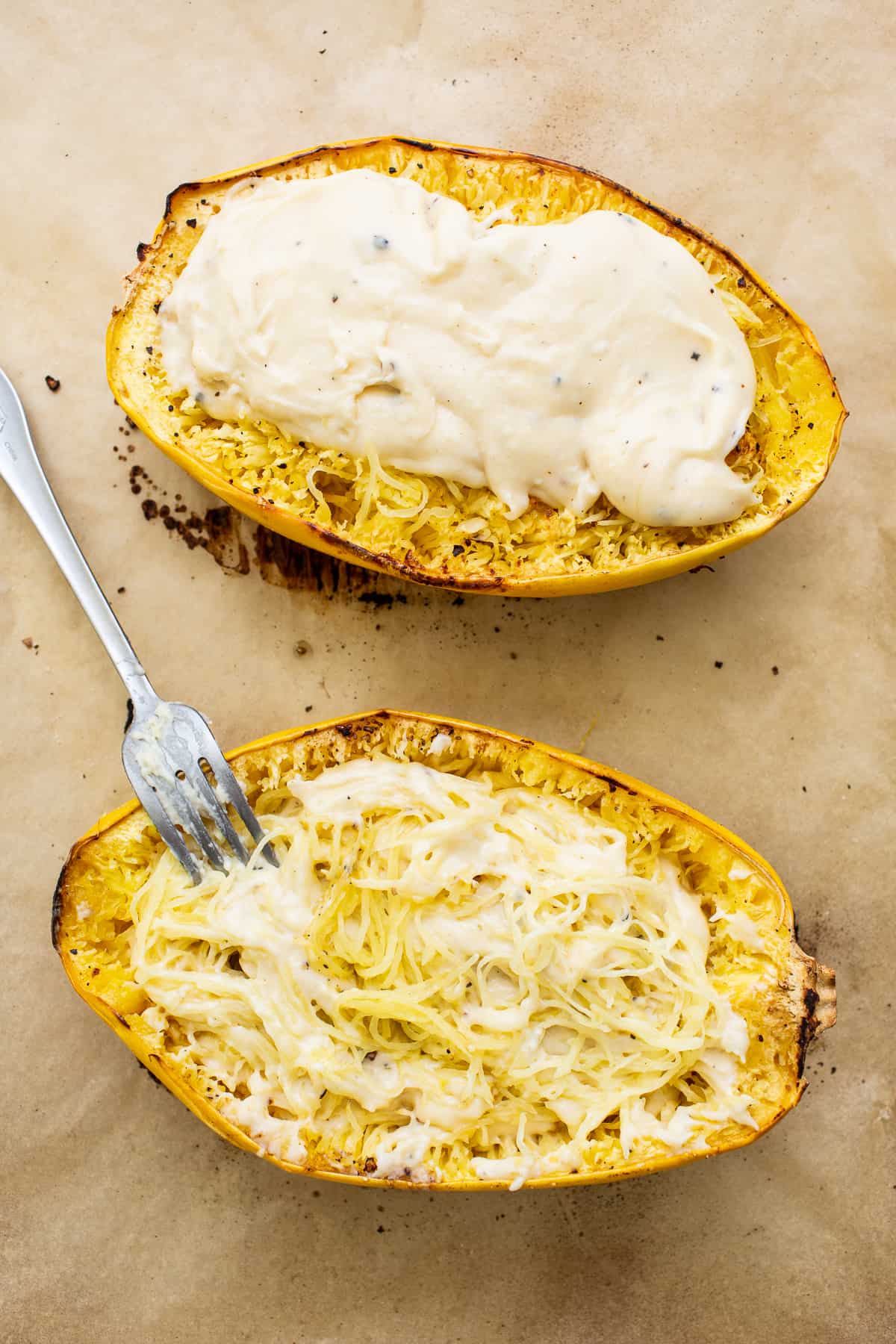 Spaghetti squash and cheese sauce on a baking sheet.