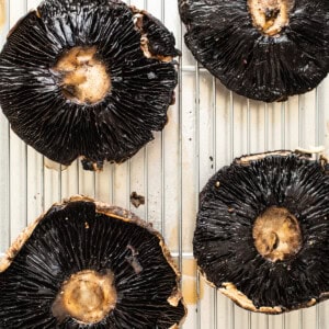 Portobello mushrooms on a baking sheet.