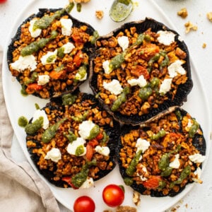 Stuffed portobello mushrooms on a plate.