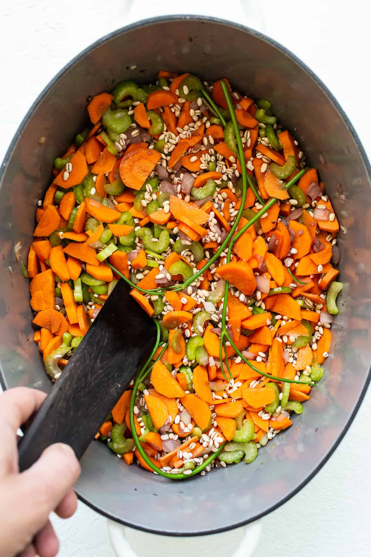 veggies and barley in pot.