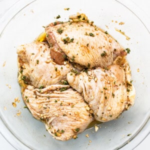 Chicken thighs in a bowl.