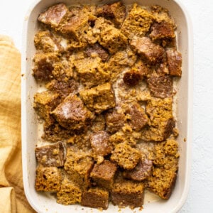 submerging pumpkin bread in baking dish.