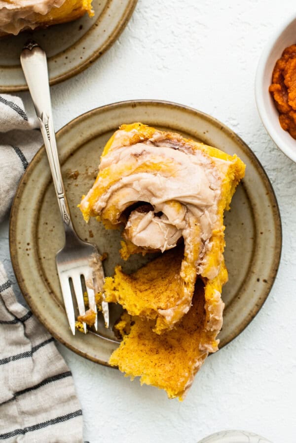 Pumpkin cinnamon roll on a plate.