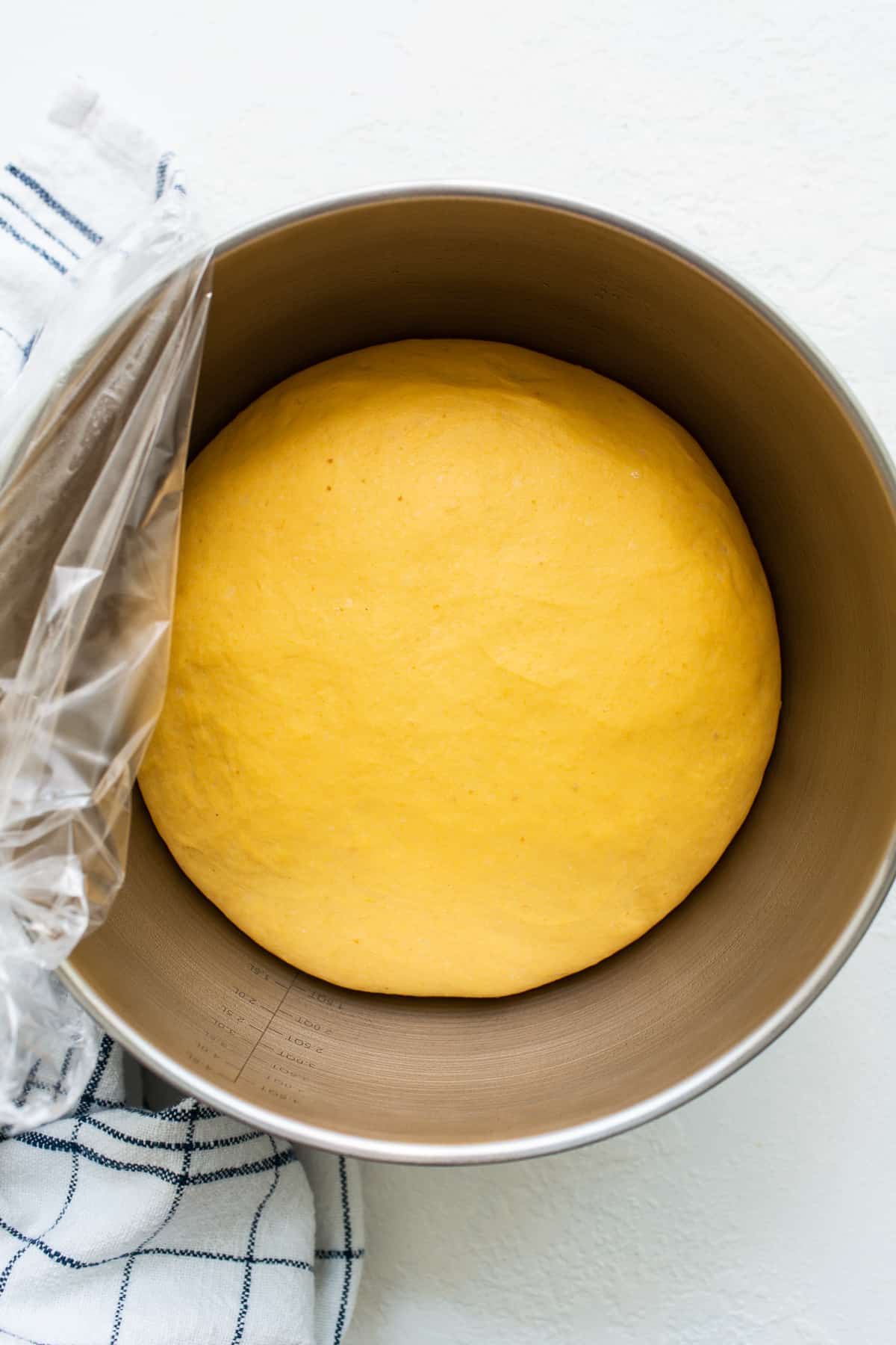 Pumpkin cinnamon roll dough in a bowl.