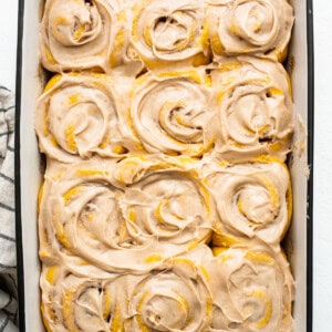 Pumpkin cinnamon rolls in a baking dish.