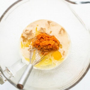 A bowl filled with ingredients for sweet potato pancakes.