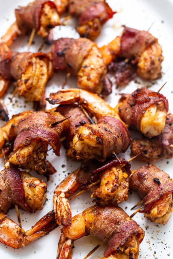 Bacon wrapped shrimp on a plate.