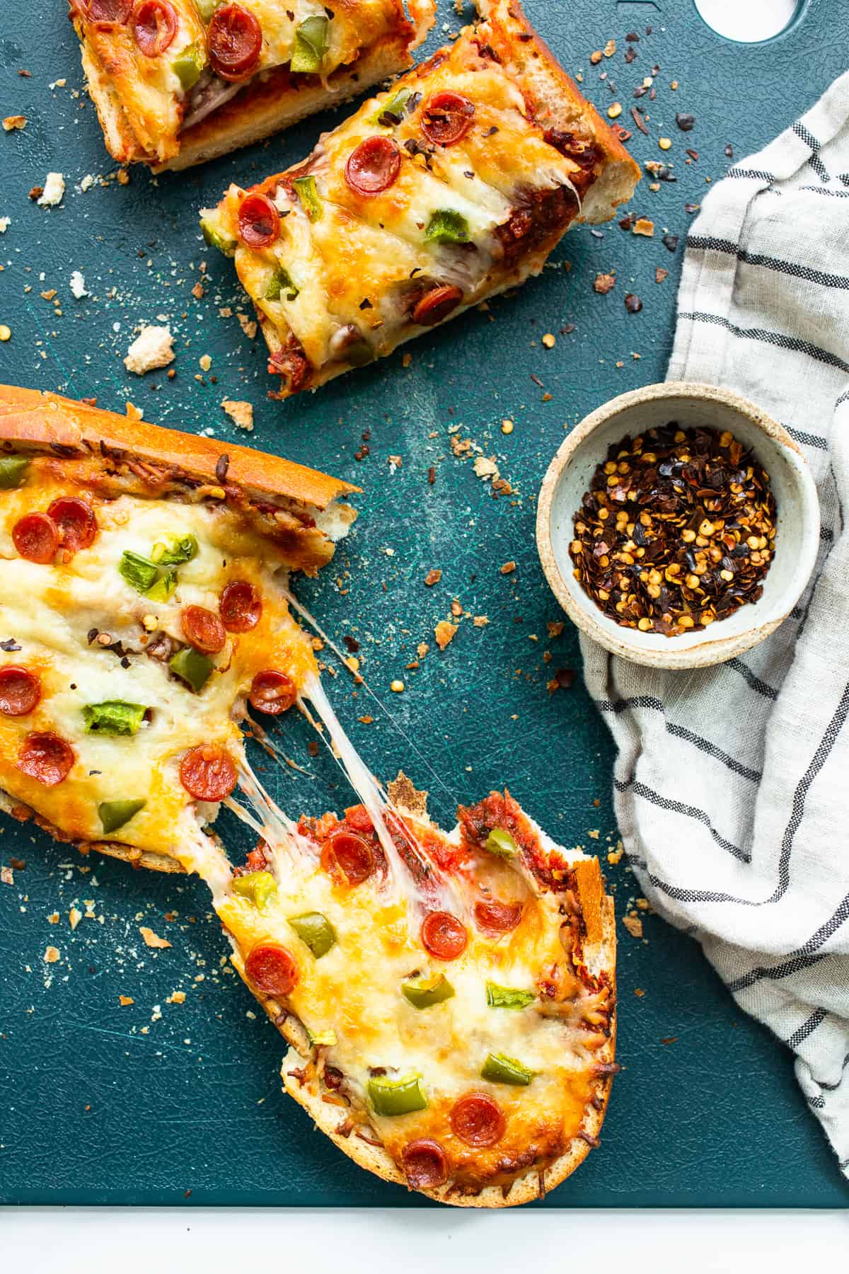 Homemade pizza slices on a cutting board.